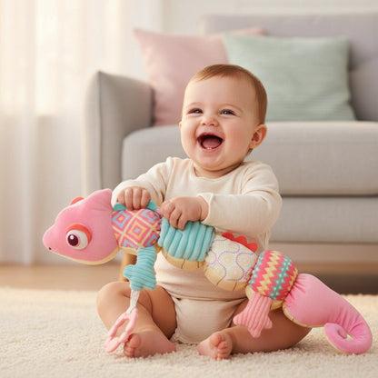La découverte sensorielle — bébé qui étire et presse la partie accordéon bleue du caméléon sensoriel en riant