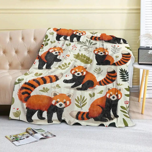 Couverture polaire panda roux étalée sur un canapé - Choupinoo